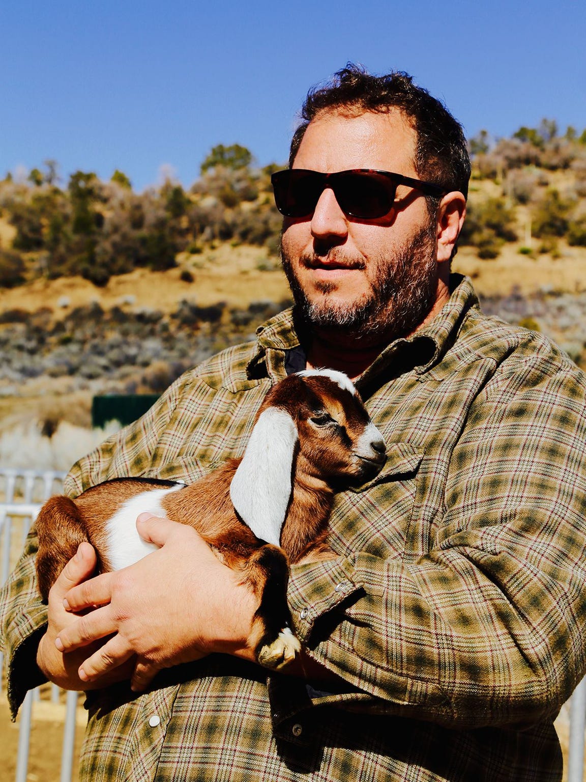 Rick Marino holds a baby goat at Angeles Crest Creamery. (Photo: Brandy Menefee)